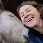 Photo of author, Dorothy Heffernan, smiling with an equid
