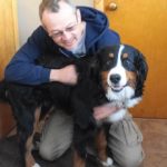 Dan during a training session with his canine student Jackson (a large black, white and brown dog)